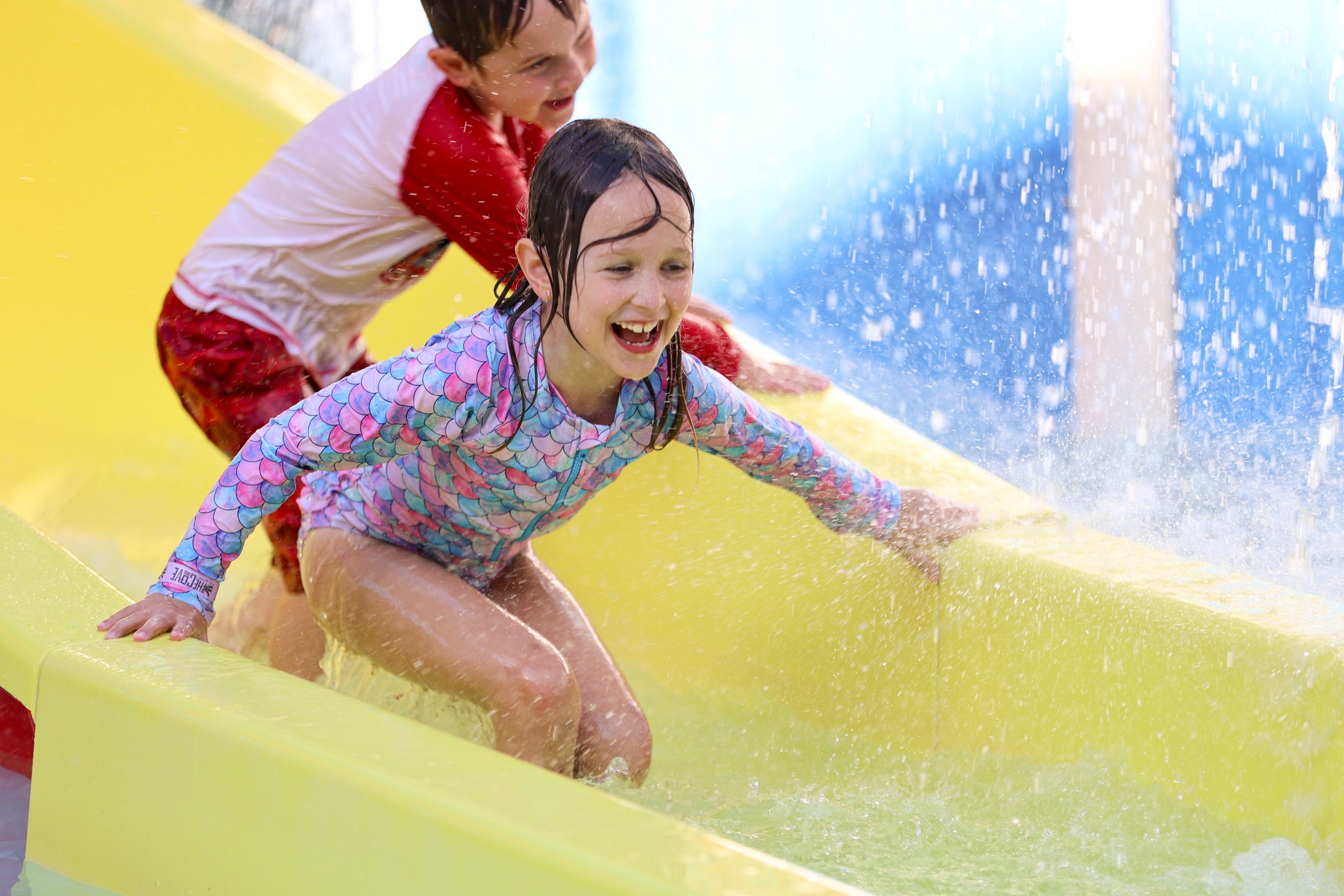 KIndergarteners having fun on the slide at The Cove at Lakefront